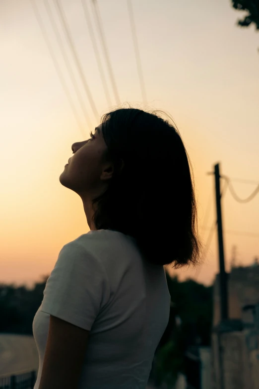 a woman who is looking up at the sky