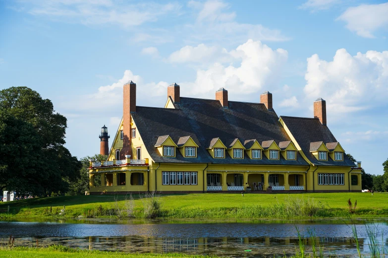 a large yellow house with a lot of windows and a brown roof