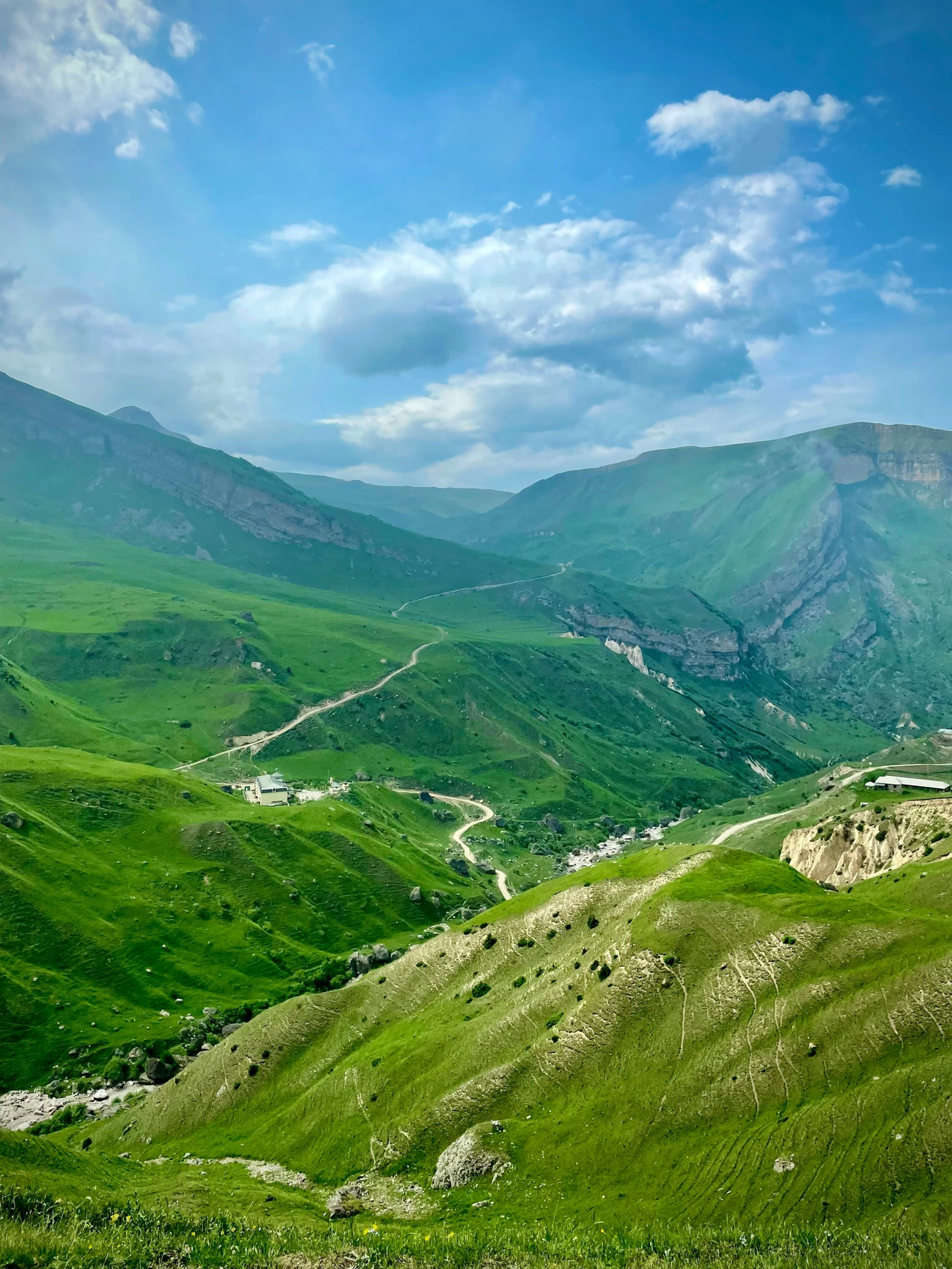 a view of a valley with mountains and valleys below