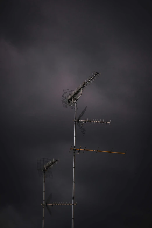 a tall tower of metal pipes under a dark sky