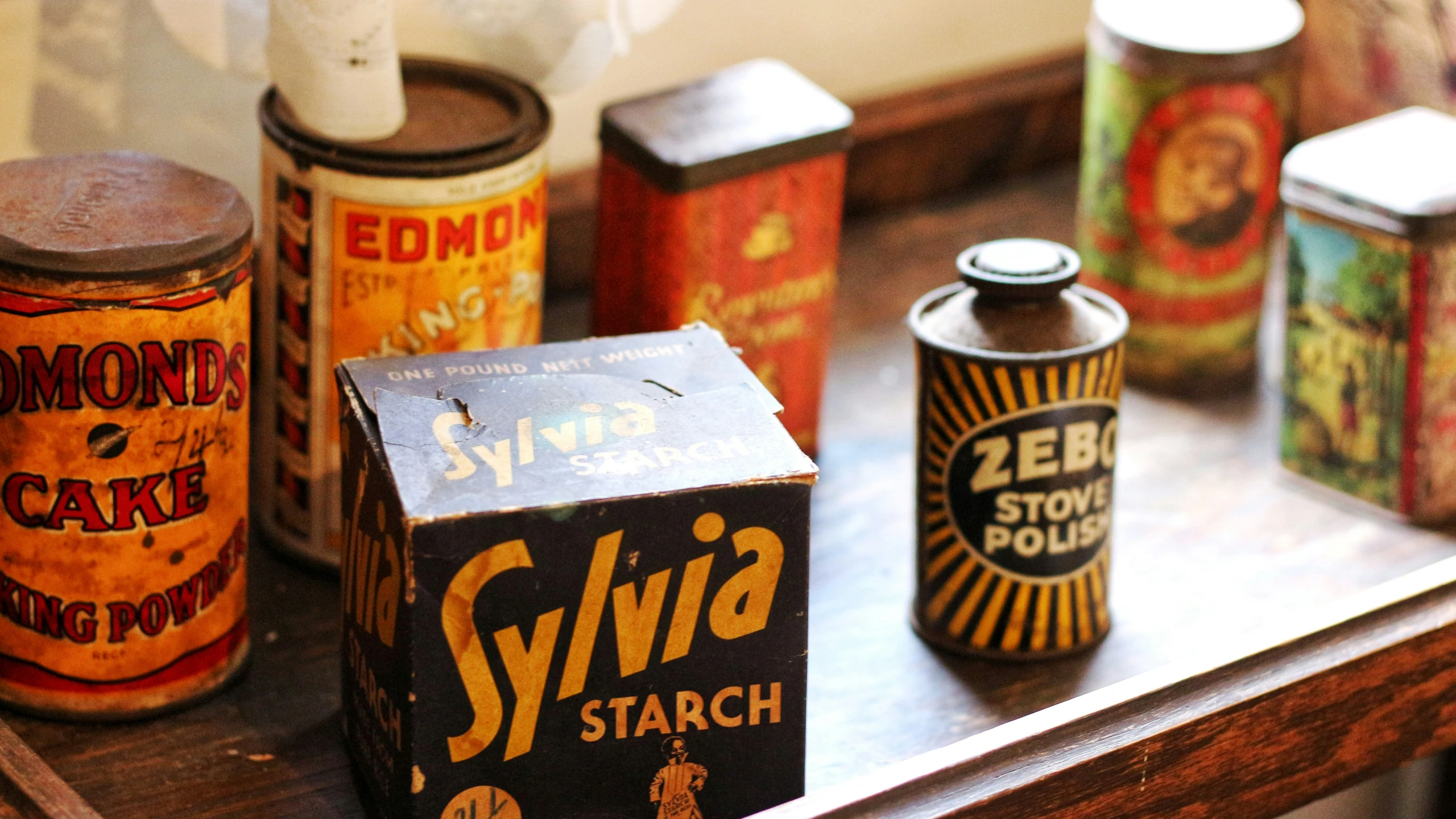 a group of colorful tins on a table