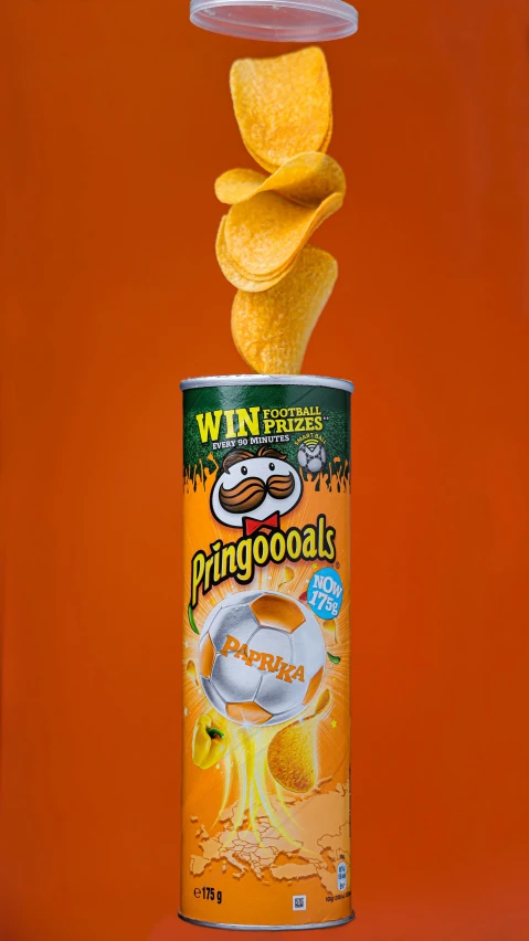 orange chips are in a can against an orange background