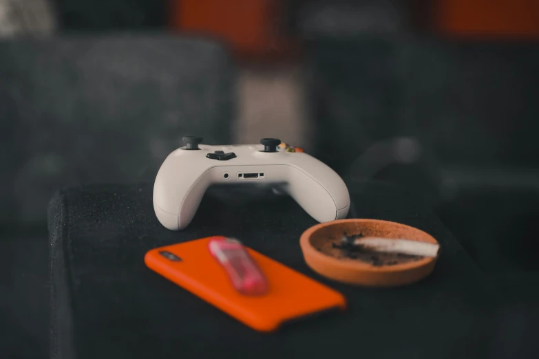 an orange bowl with a white game controller on it