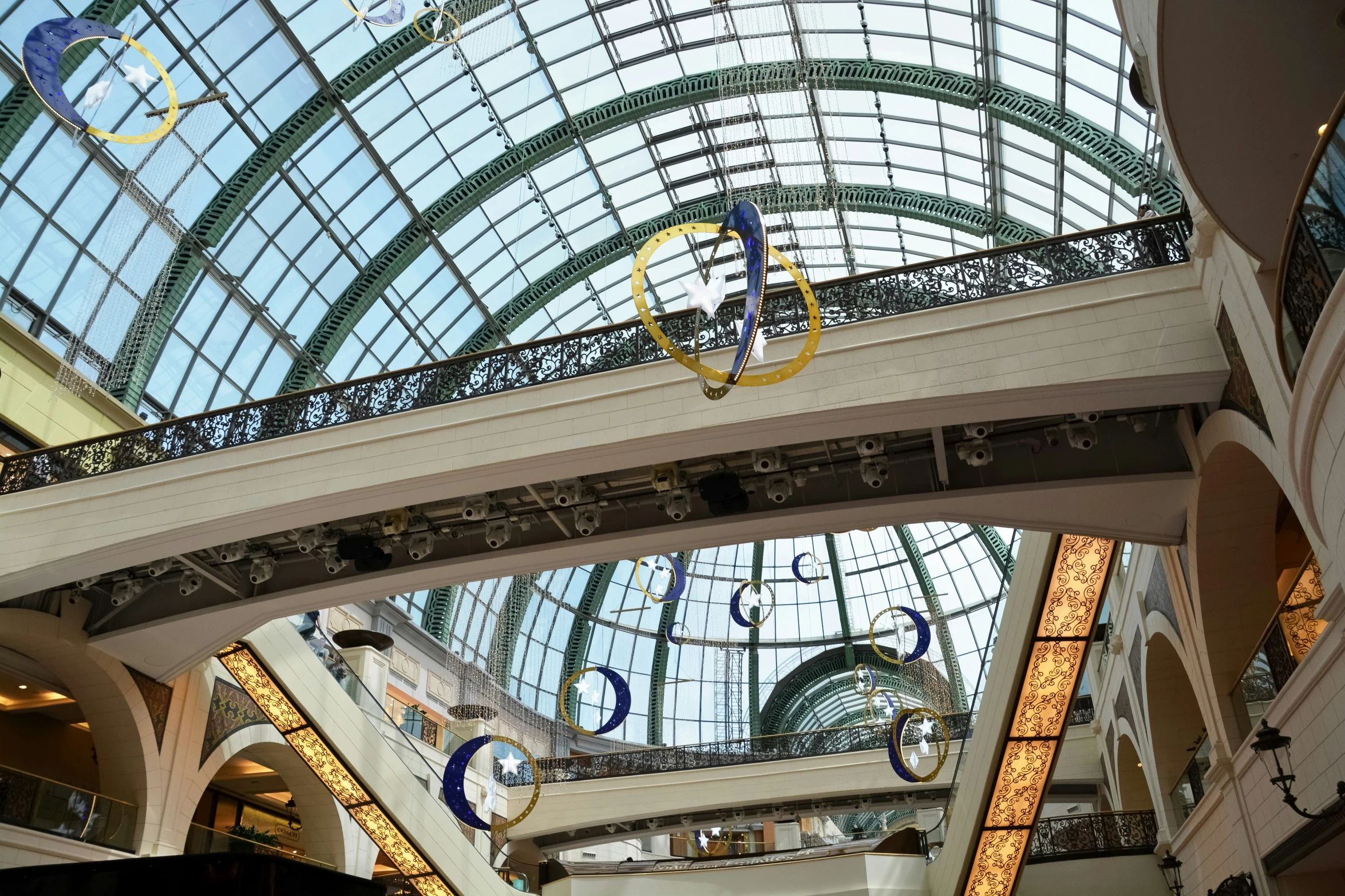 the ceiling of a mall with various hanging ornaments