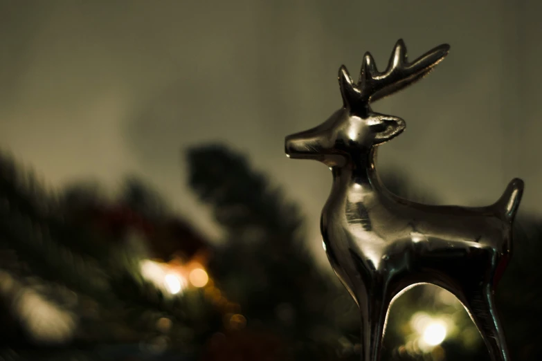 a silver statue of a deer on top of a wooden table