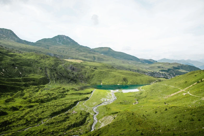 a lush green valley surrounded by mountains