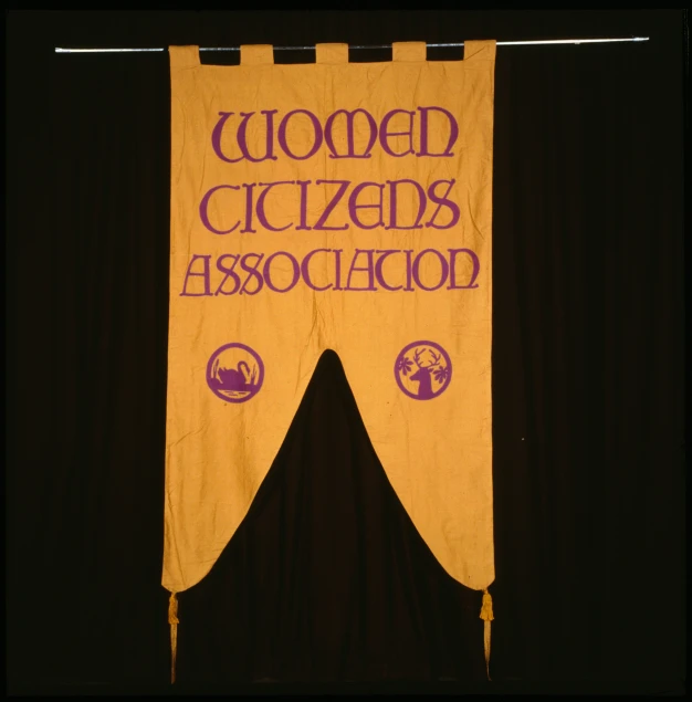 a banner with words drawn across it sitting on a shelf