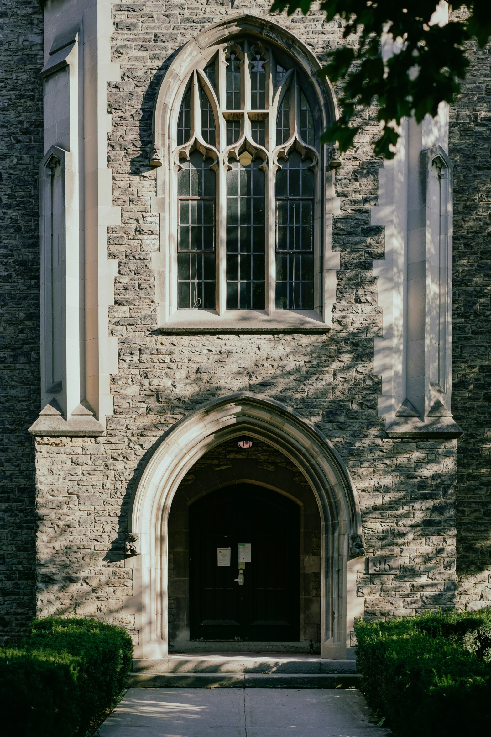 an old church with a clock on the front door