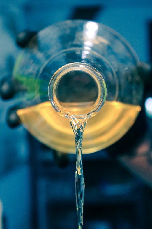 water pours into the cup that is in front of a plate