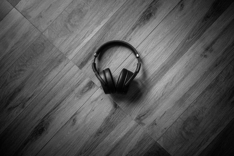a headphone laying on the floor in black and white