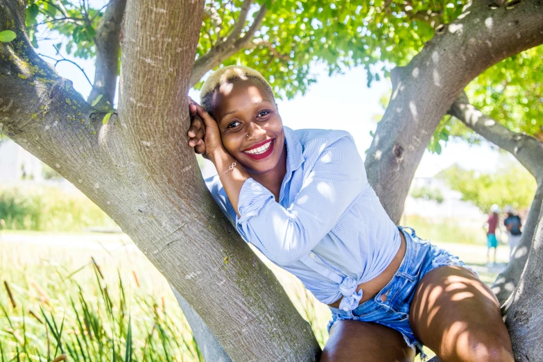 a young woman posing with her hair in a ponytail in a tree