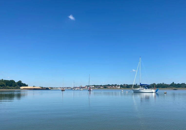 a small sailboat that is in the middle of the water