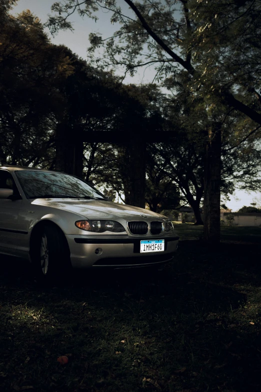 there is a car parked next to a tree