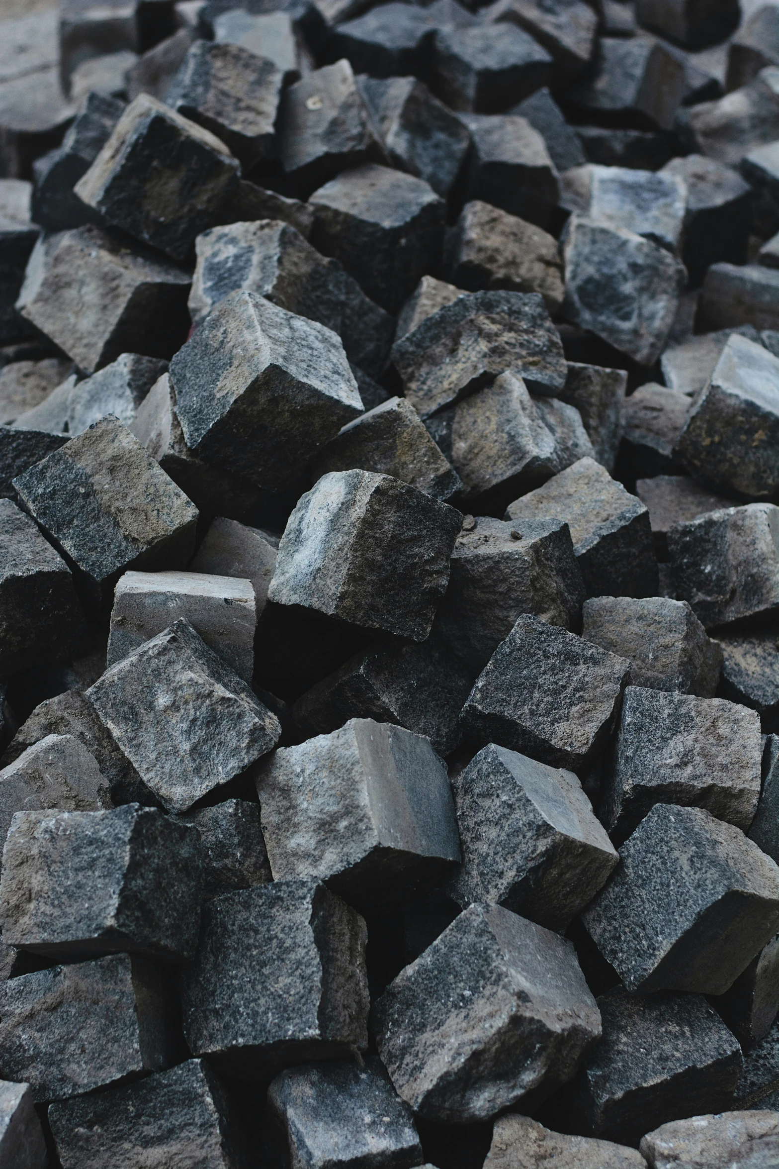 several dark gray rocks are piled together