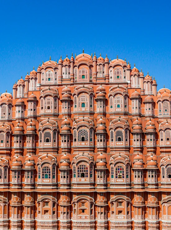 a very tall red brick building with lots of windows