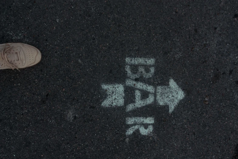 a close up view of the asphalt with graffiti on it