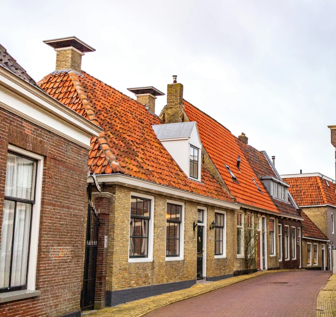 the city with several brick buildings and red roof tops