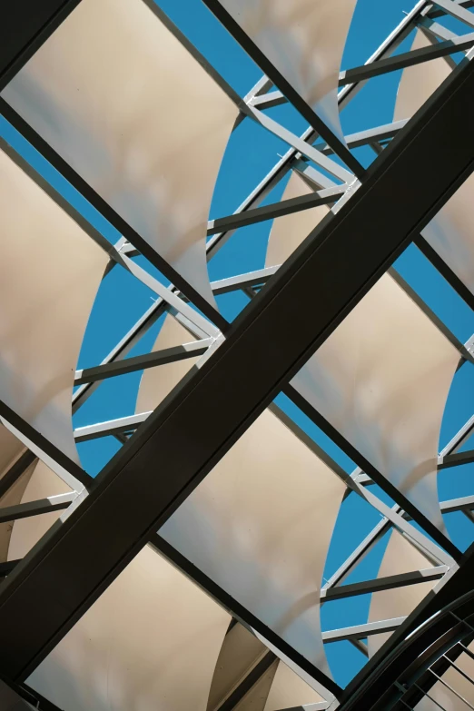 a clock hanging from the ceiling of a building