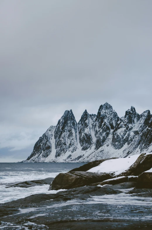 an image of a snowy mountain scene with rocks