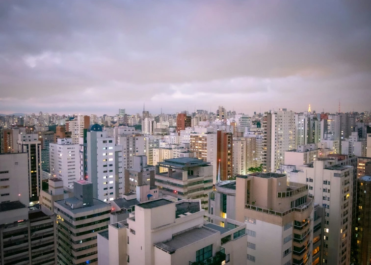 cityscape with high - rise buildings at dusk