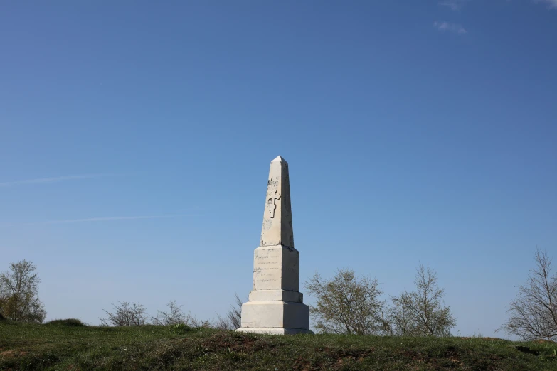 a large monument sits on top of a hill