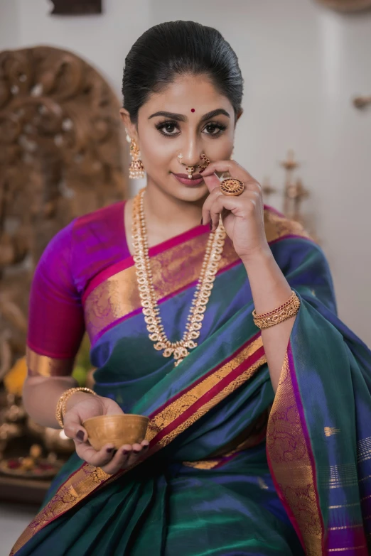 a woman with indian jewelry poses for the camera
