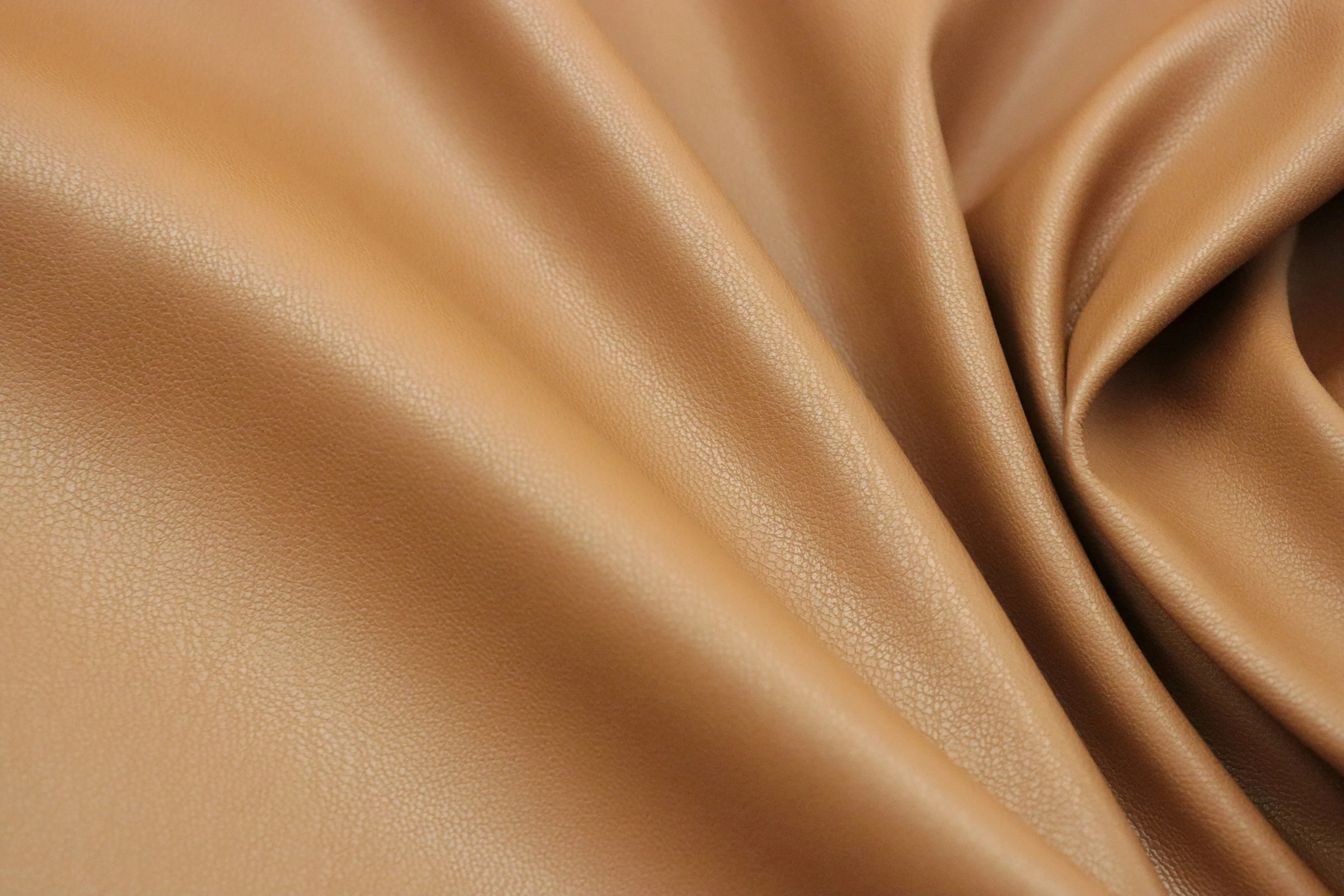 the texture of brown fabric with shiny folds