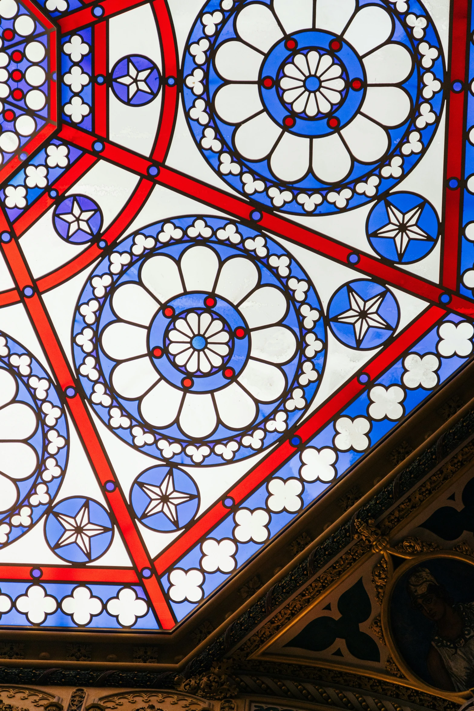 a unique and beautiful stained glass ceiling inside of a building