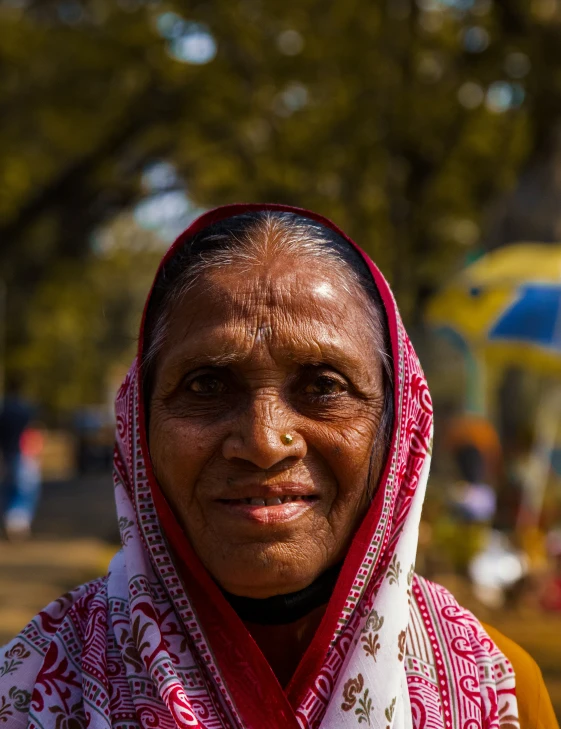 a woman is smiling with a red scarf around her