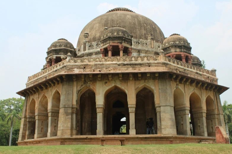 an old, crumbling looking building with several domes