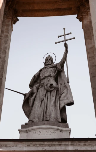 a statue of saint joseph holding the crosses and a cross