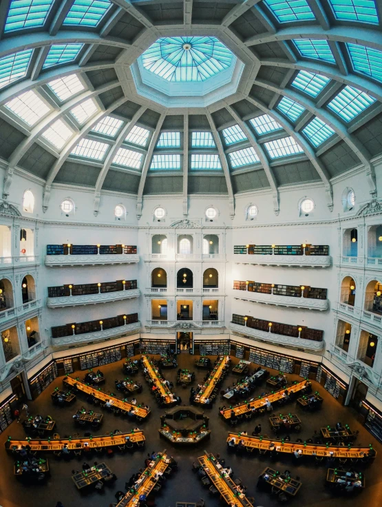 the inside of a building with tables and benches