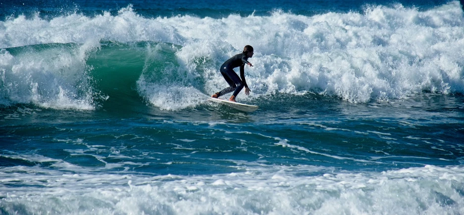 a man on a surfboard in the water with breaking waves