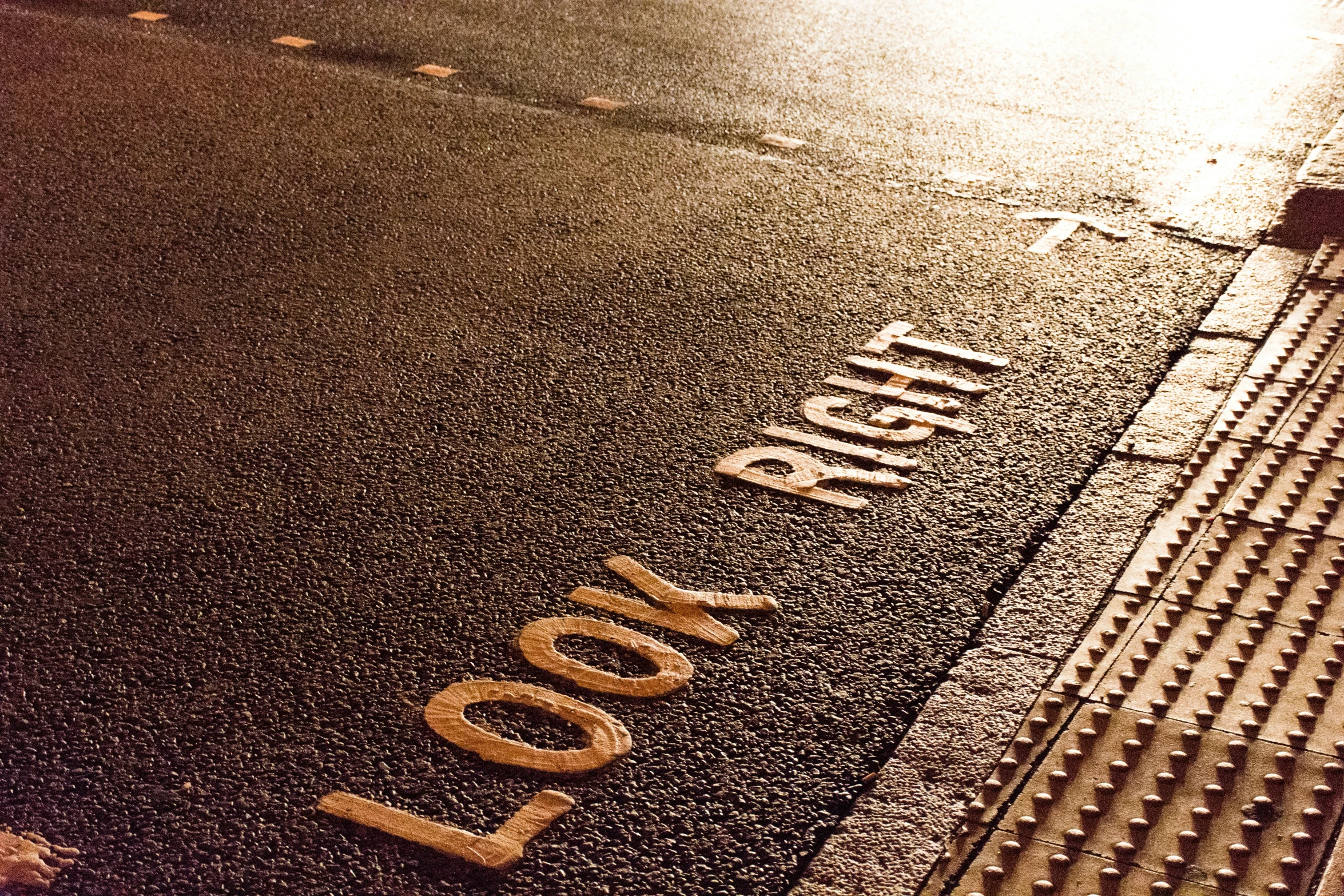 a sign sitting in the road that says love on the side of the street