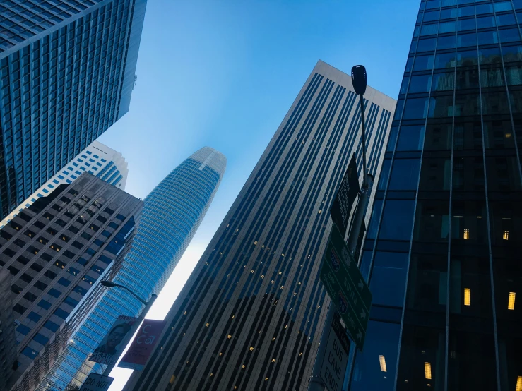 three tall building are in the city at night