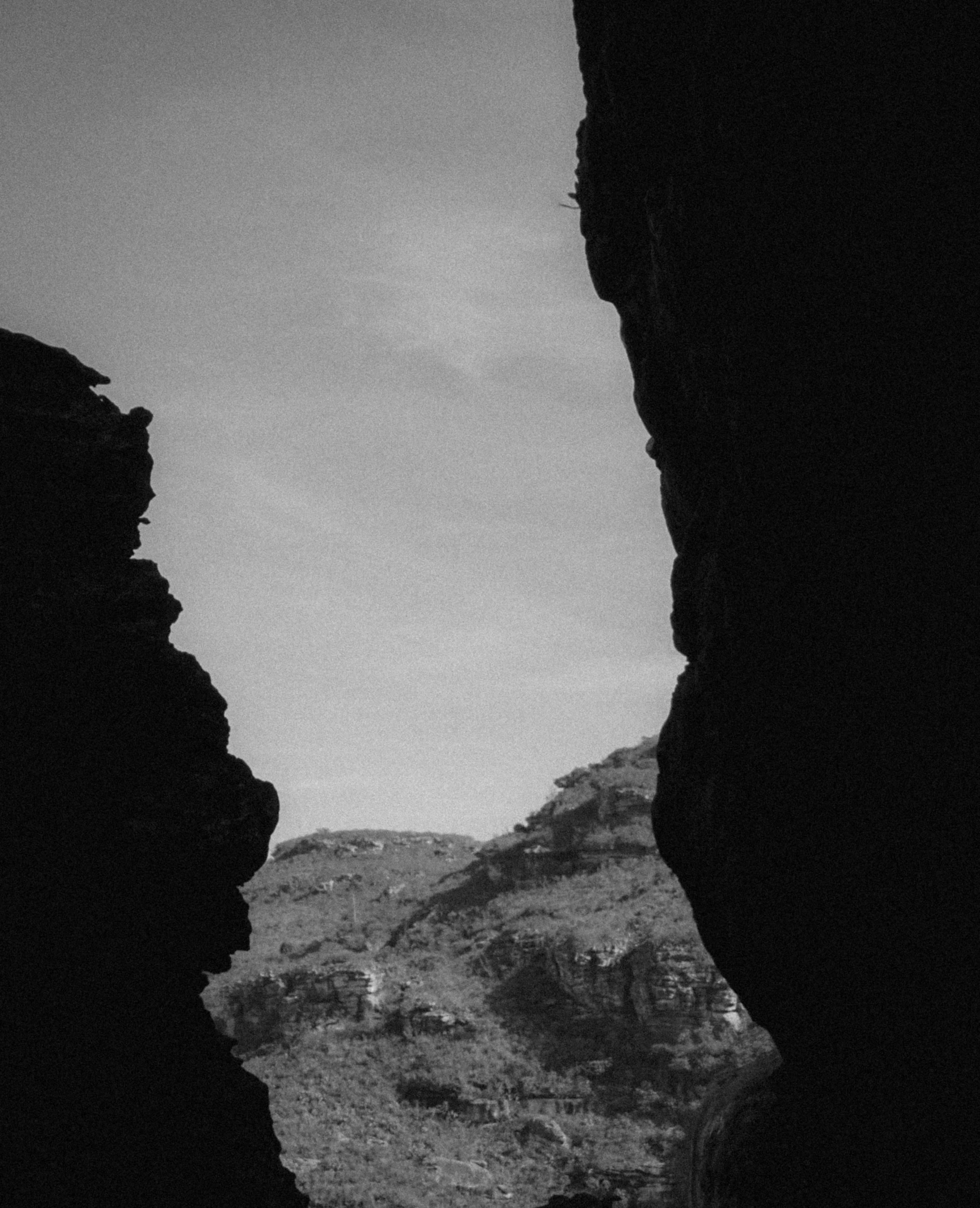 a person walking on rocks near mountains