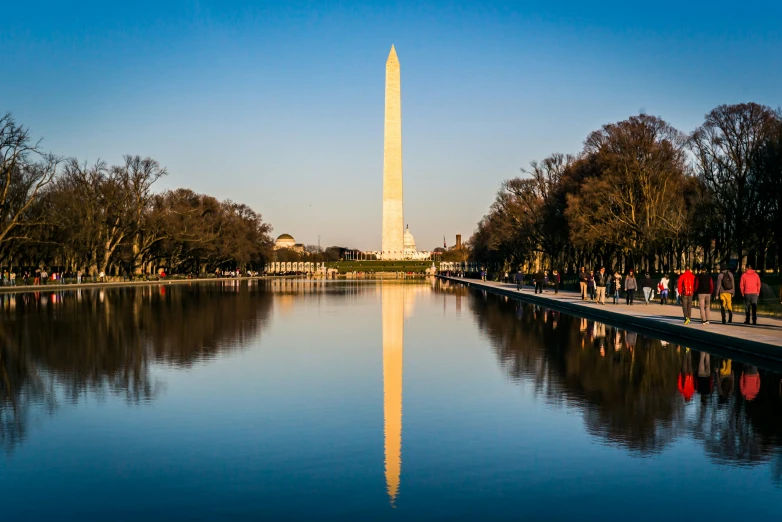 the washington monument and reflecting lake at sunset