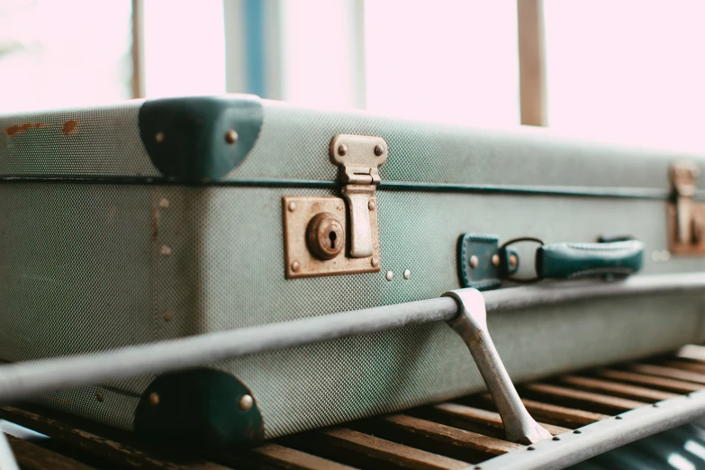 a suitcase sitting on a metal rack near a window