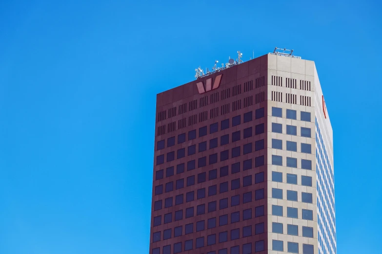 a tall red and white building next to another building