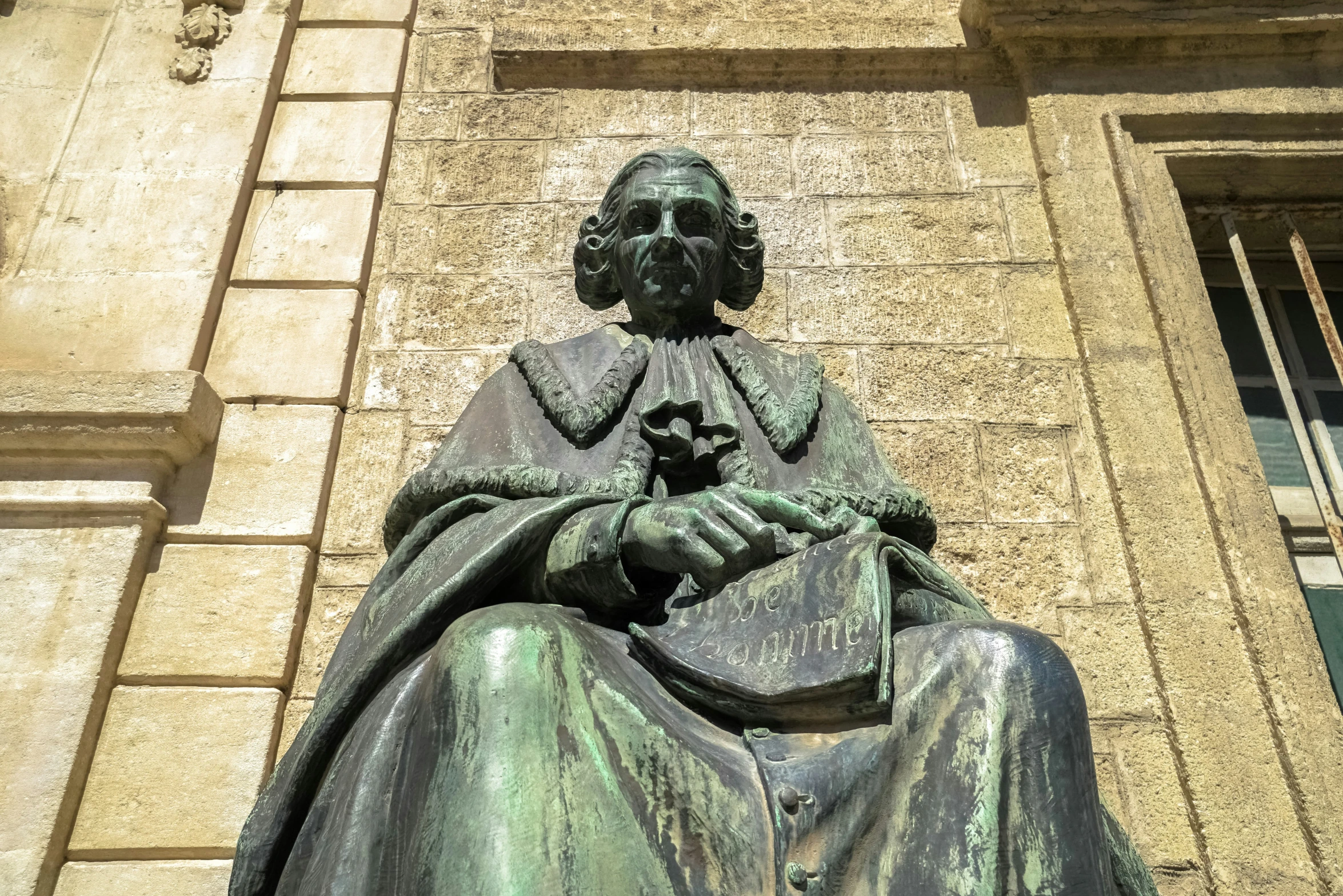 there is a statue of the famous dr thomas potter in front of a building