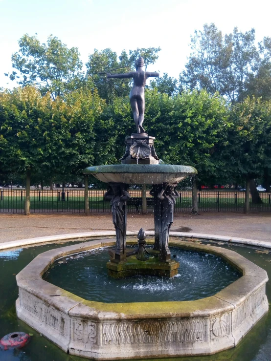 a fountain that has a statue on top