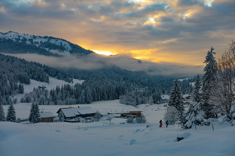 the sun is setting on a ski resort