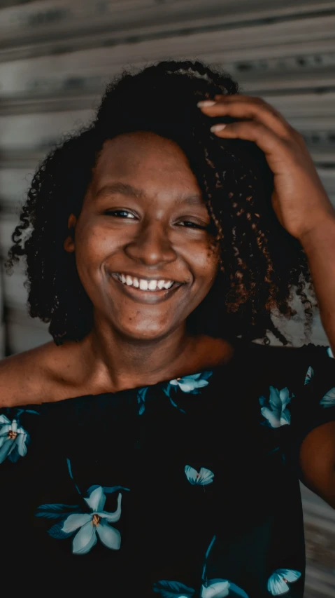 the smiling woman in the black top smiles