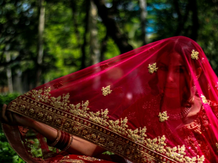 a woman dressed in a red sari