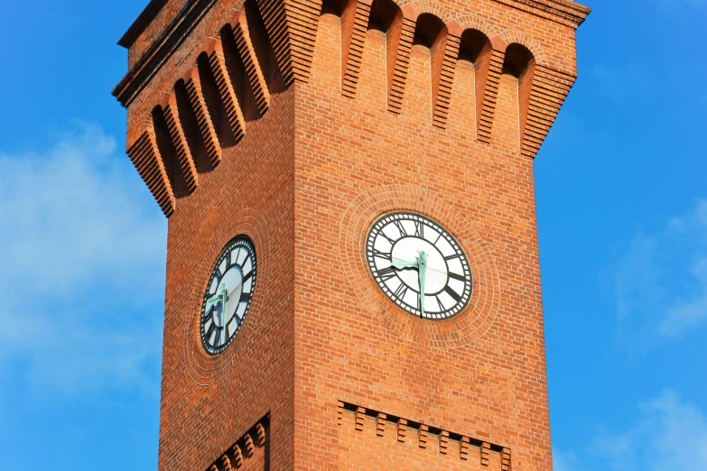 the tower is tall with two clocks on each side