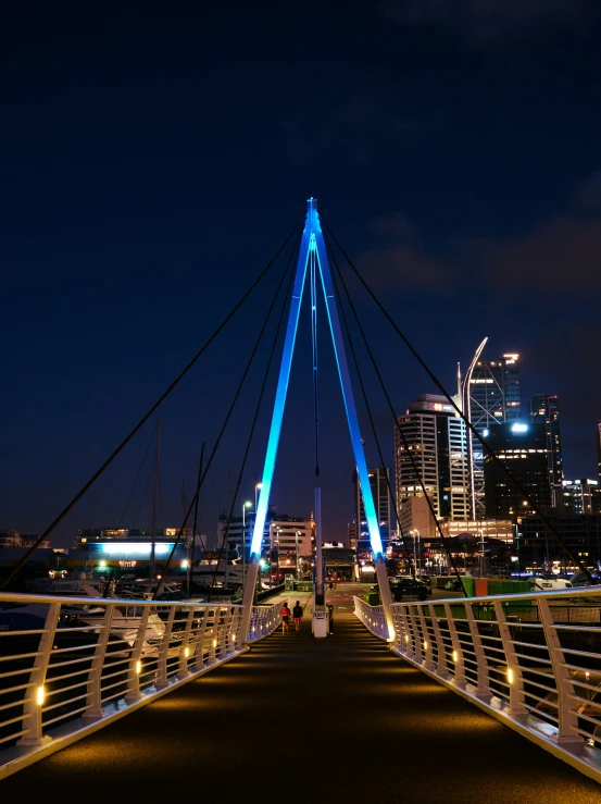 view of an illuminated pedestrian bridge crossing river thames at night