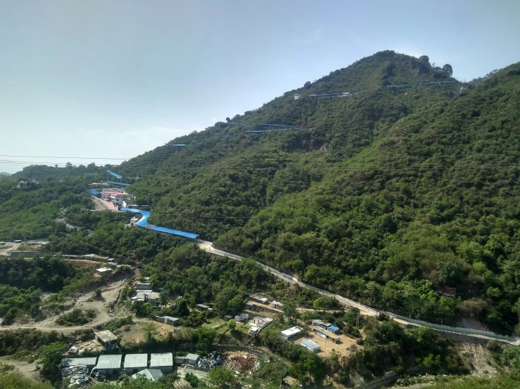 a view from a plane of many buildings and hills