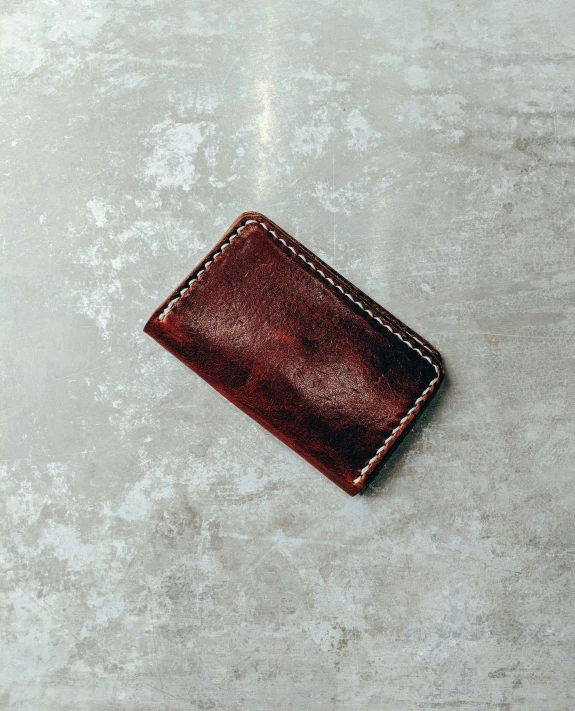 a piece of leather sitting on a stone surface