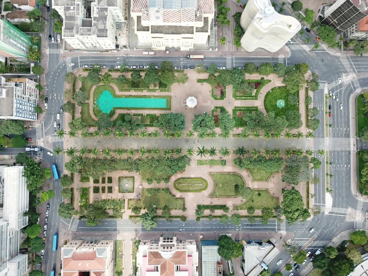 an aerial view shows streets and buildings and green trees