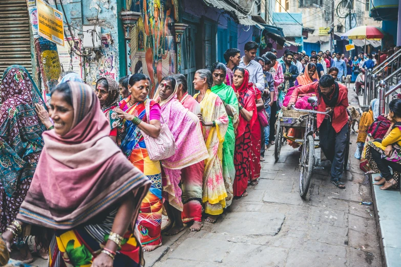 a large group of people walk down a street